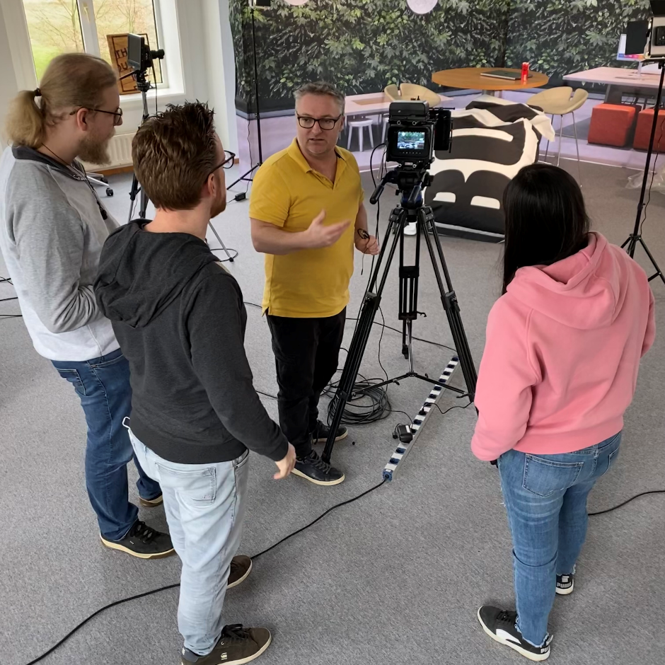 Michiel (gele polo) geeft enkele van de kandidaten uitleg.